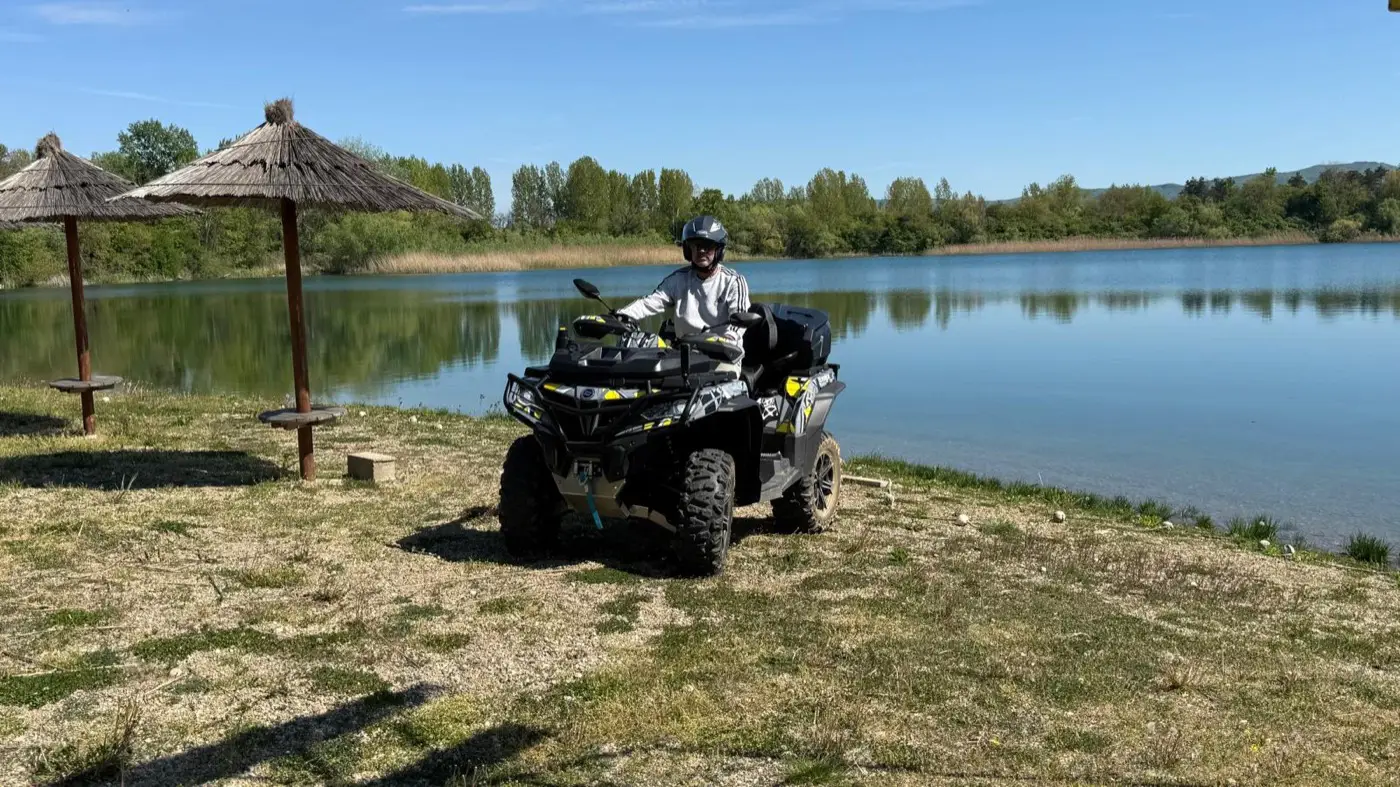 A Mad Max quad bike parked by the Bela Crkva lake under a clear blue sky