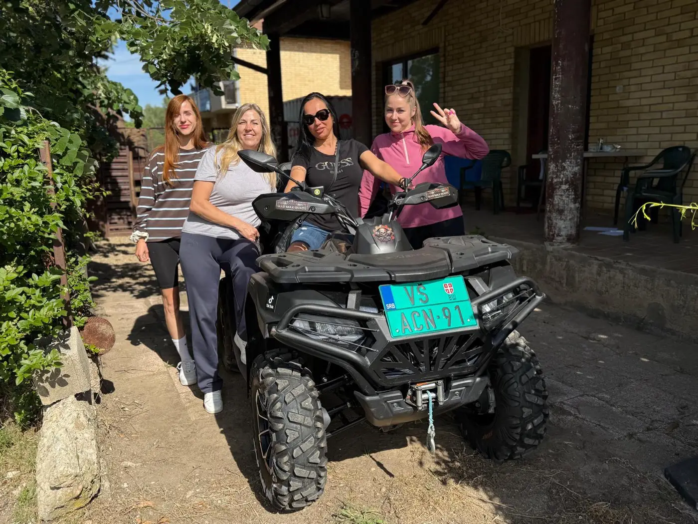A group of four friends gathered around a Mad Max quad bike in Bela Crkva