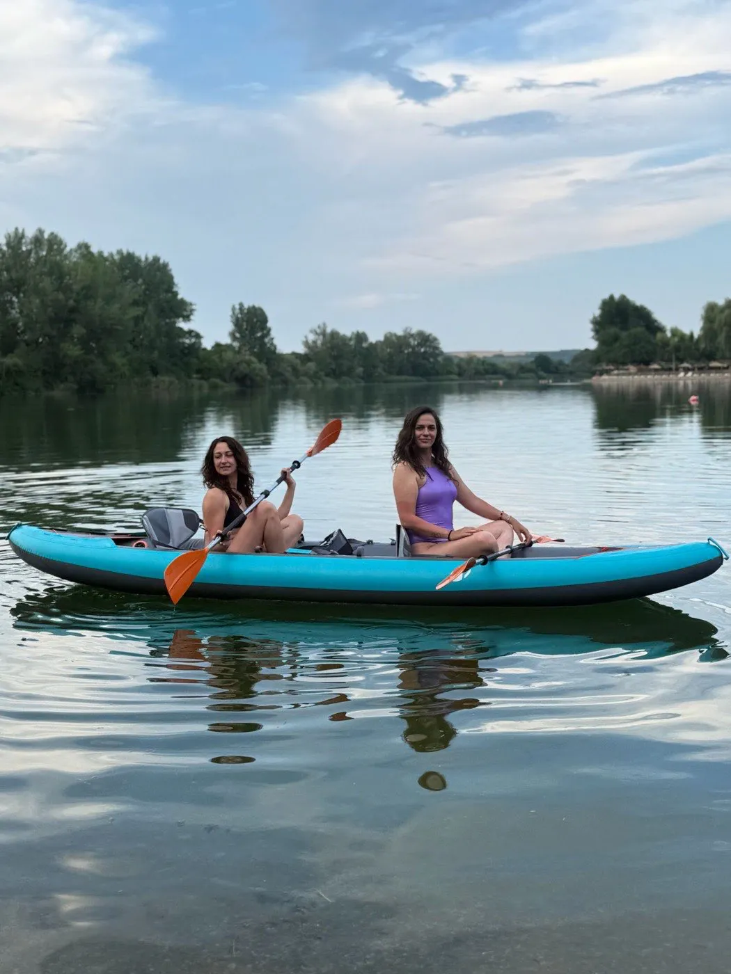 Side view of a two-person kayak on the still Bela Crkva lake water